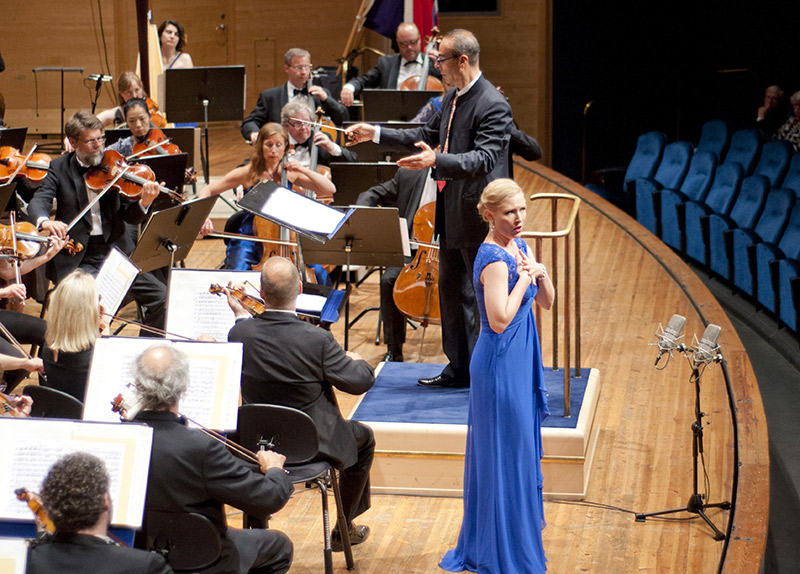 Orchestra on a scene and a woman singing