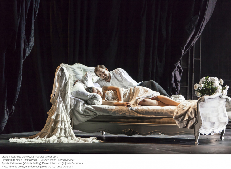 Woman and a man in a bed on stage