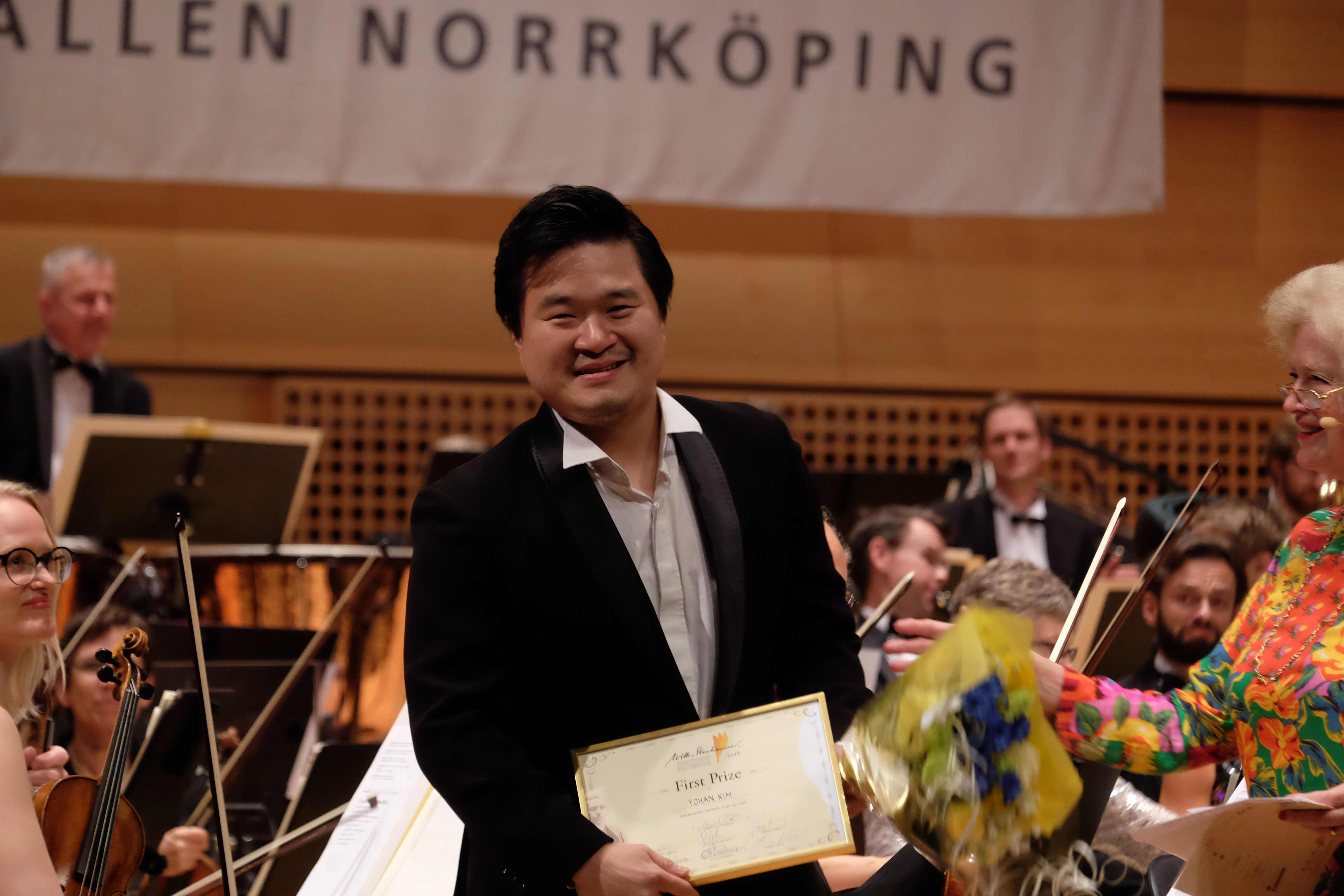 A man on stage with the first prize